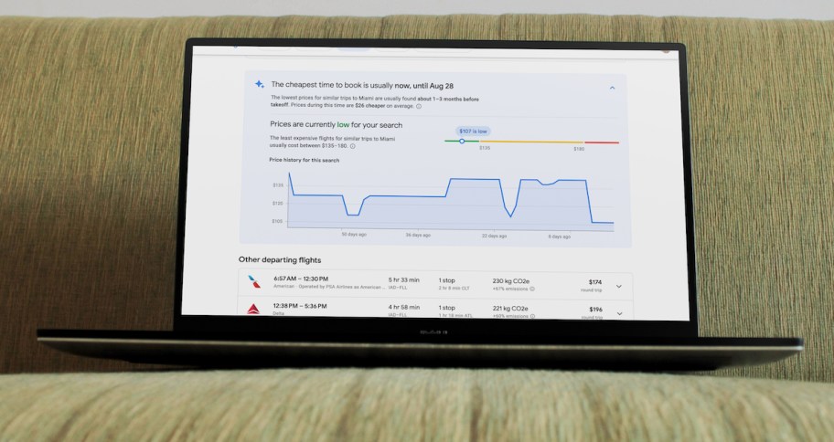 laptop with google flights price tracker on screen sitting on green couch