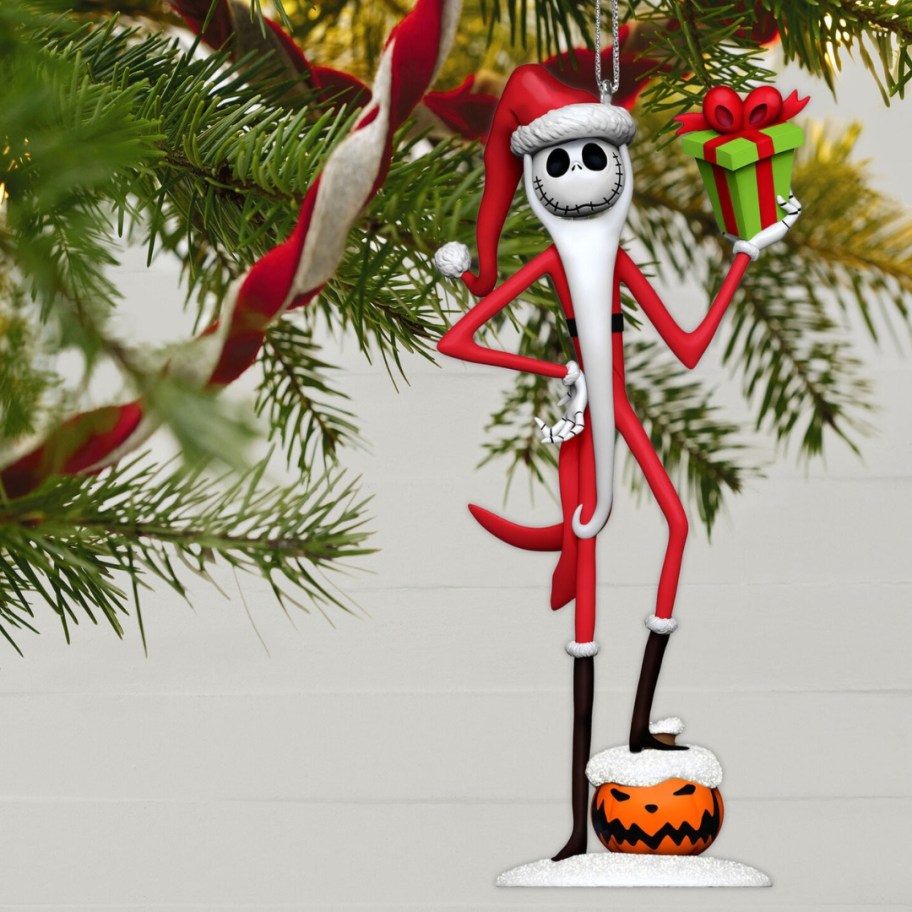 Jack Skellington in a Santa Suit Christmas ornament hanging from a tree limb