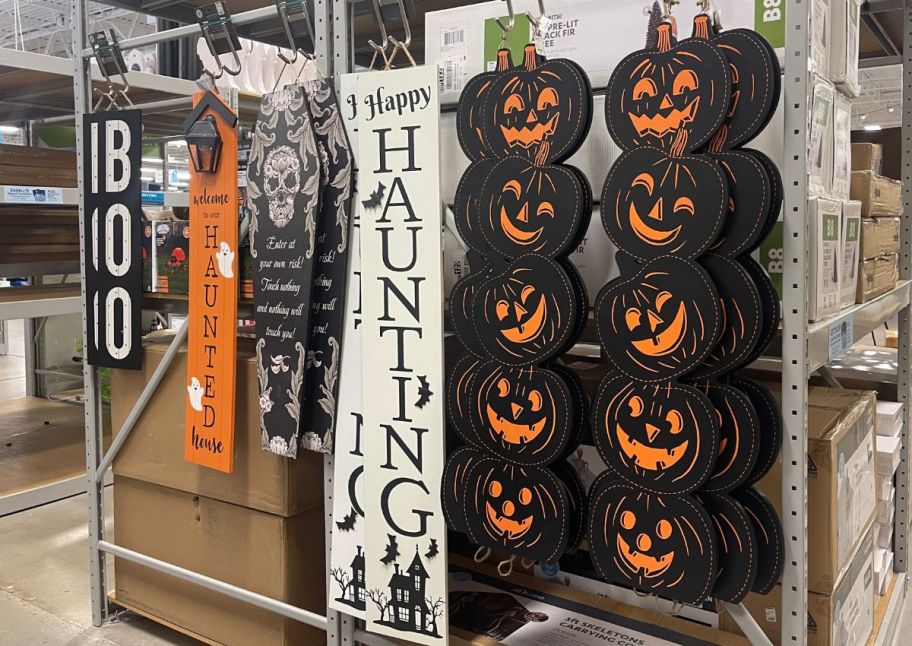 a selection of wooden porch signs in a store