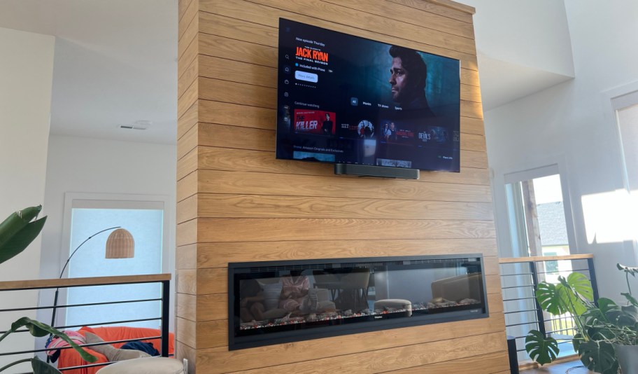 amazon prime streaming jack ryan series on a tv screen mounted on a fireplace wall