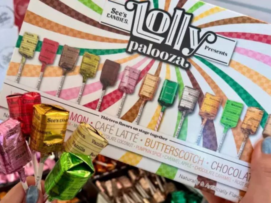 hand holding a box of lollypop 