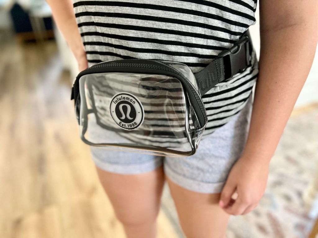 a woman wearing a lululemon clear belt bag around her waist