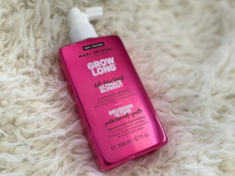 Marc Anthony Anti-Frizz Shield Ultimate Blowout Spray bottle on white fluffy blanket