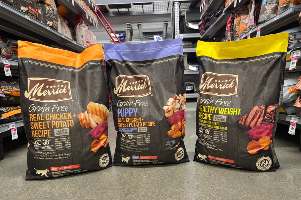 three bags of Merrick dog food on floor