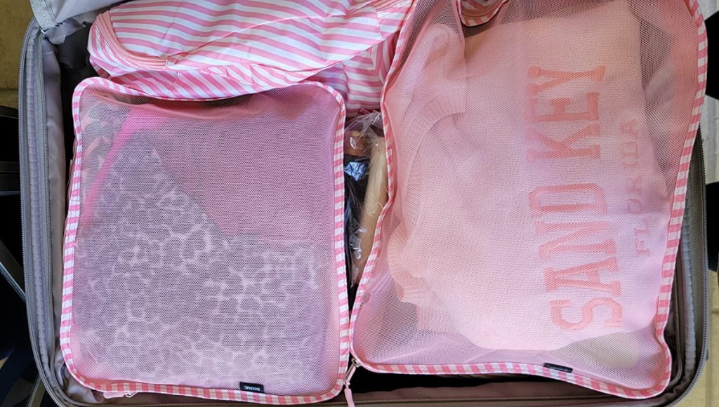 pink packing cubes in luggage