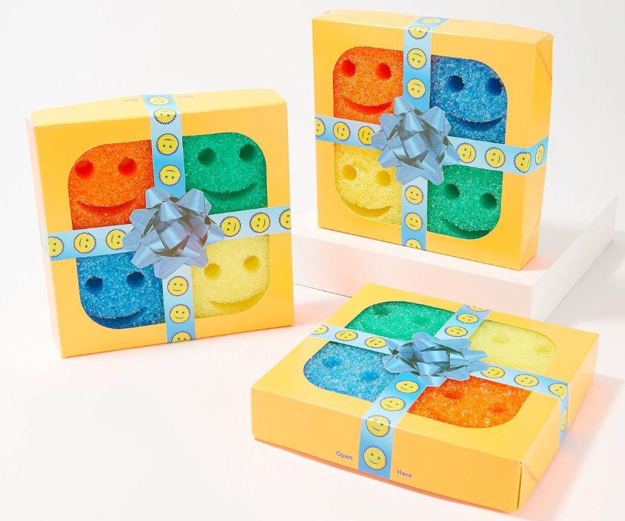 3 four packs of scrub daddy sponges displayed in box.