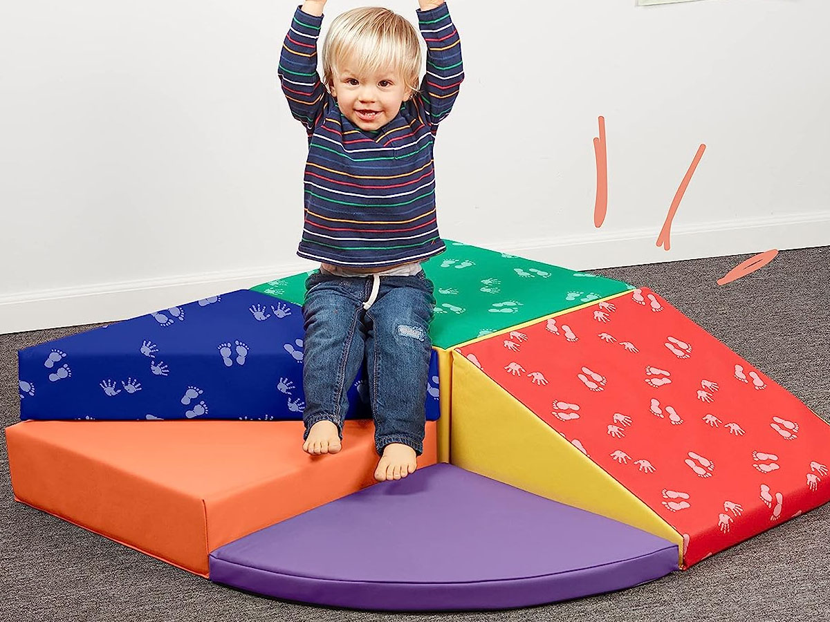 child jumping on softzone climbing playset