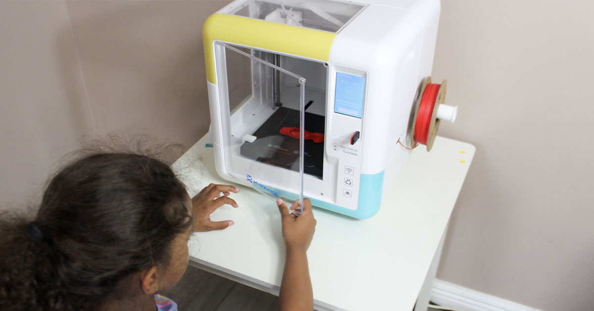 child opening white 3d printer