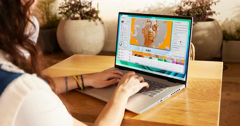 Woman using a Dell Laptop sitting at a table