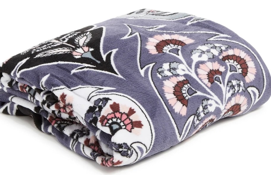 a bluish gray and floral print throw blanket folded