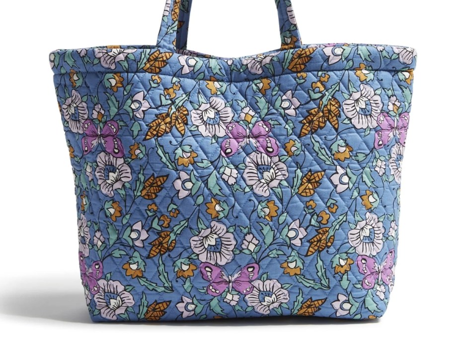 a large cotton tote bag in light blue with pink, purple, white and tan flowers and leaves