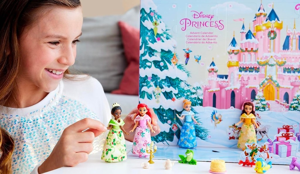 girl playing with Disney Princess Advent Calendar with dolls and pieces