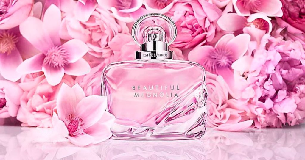 Estee Lauder Beautiful Magnolia infront of a background of pink flower petals