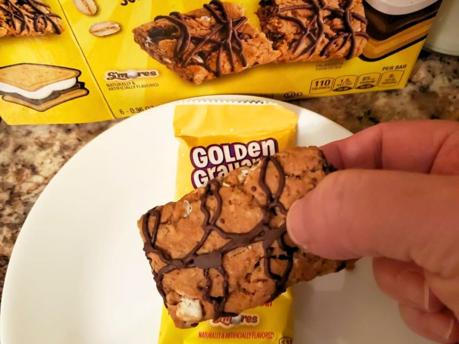 Hand holding an Open Golden Grahams Soft Baked bar