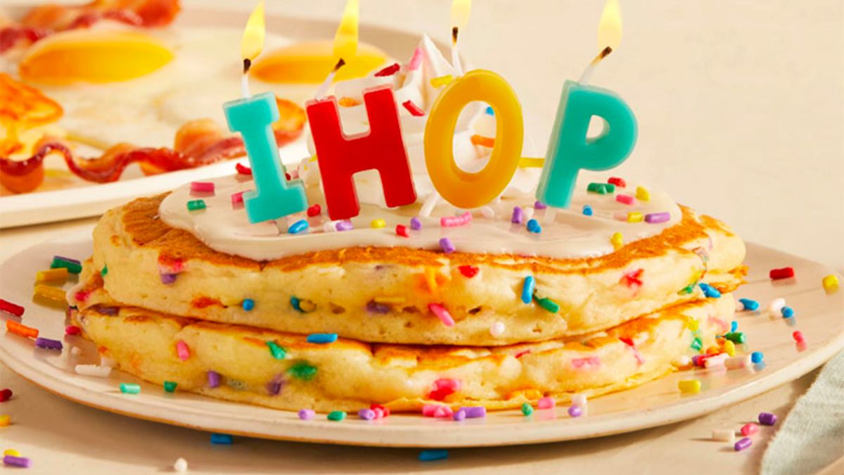 IHOP 65th birthday specials plate of ihop pancakes decorated with syrup candles and sprinkles