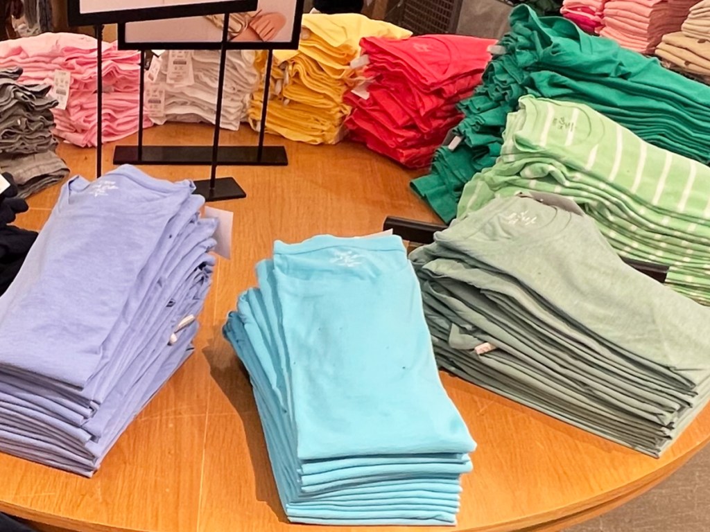 folded tees on store display table