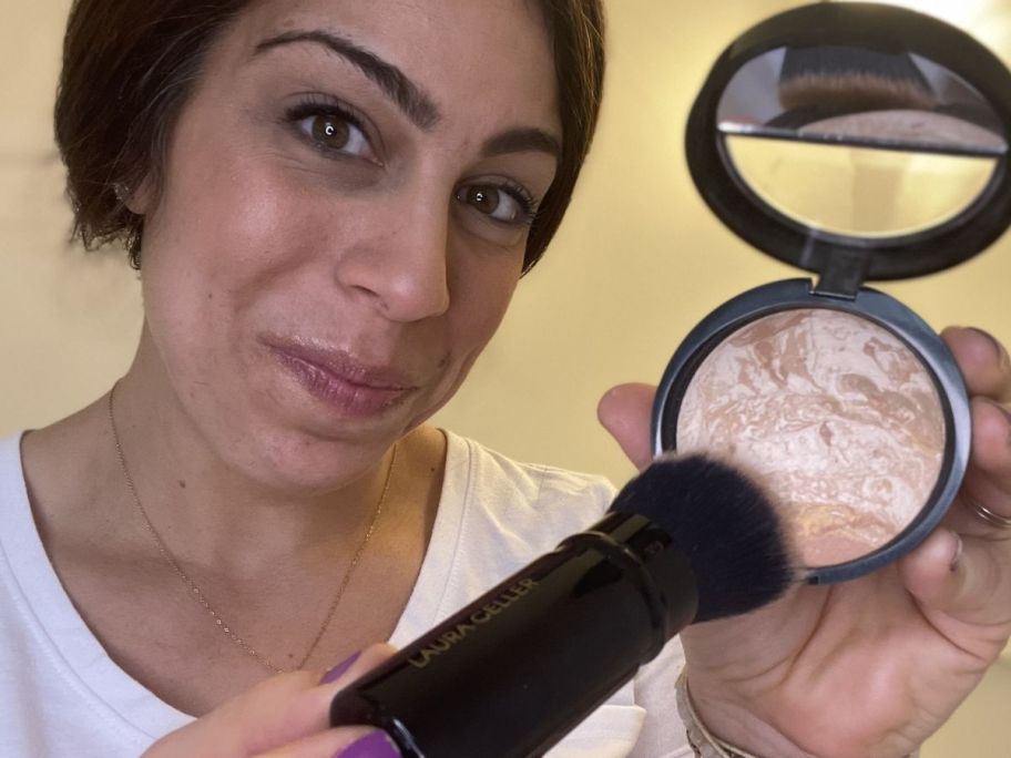 Woman using a Laura Gellar baked Foundation