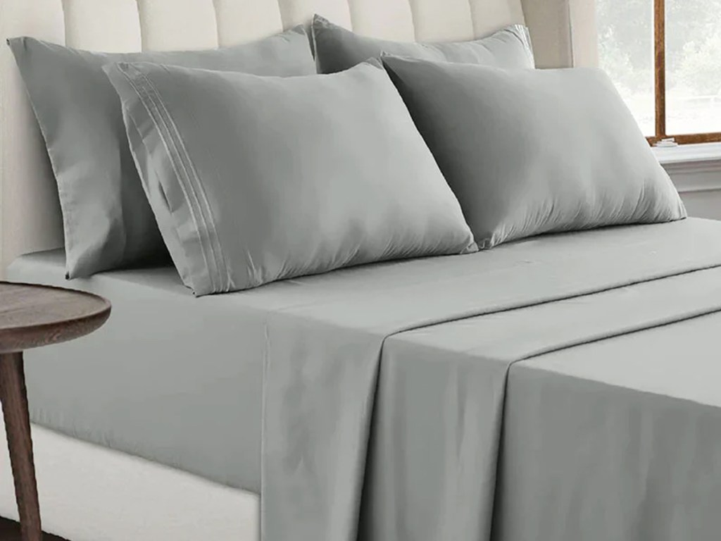 grey sheets and pillowcases on bed