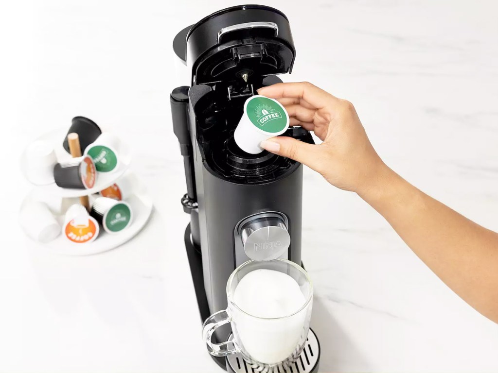 putting a coffee pod into a ninja coffee maker