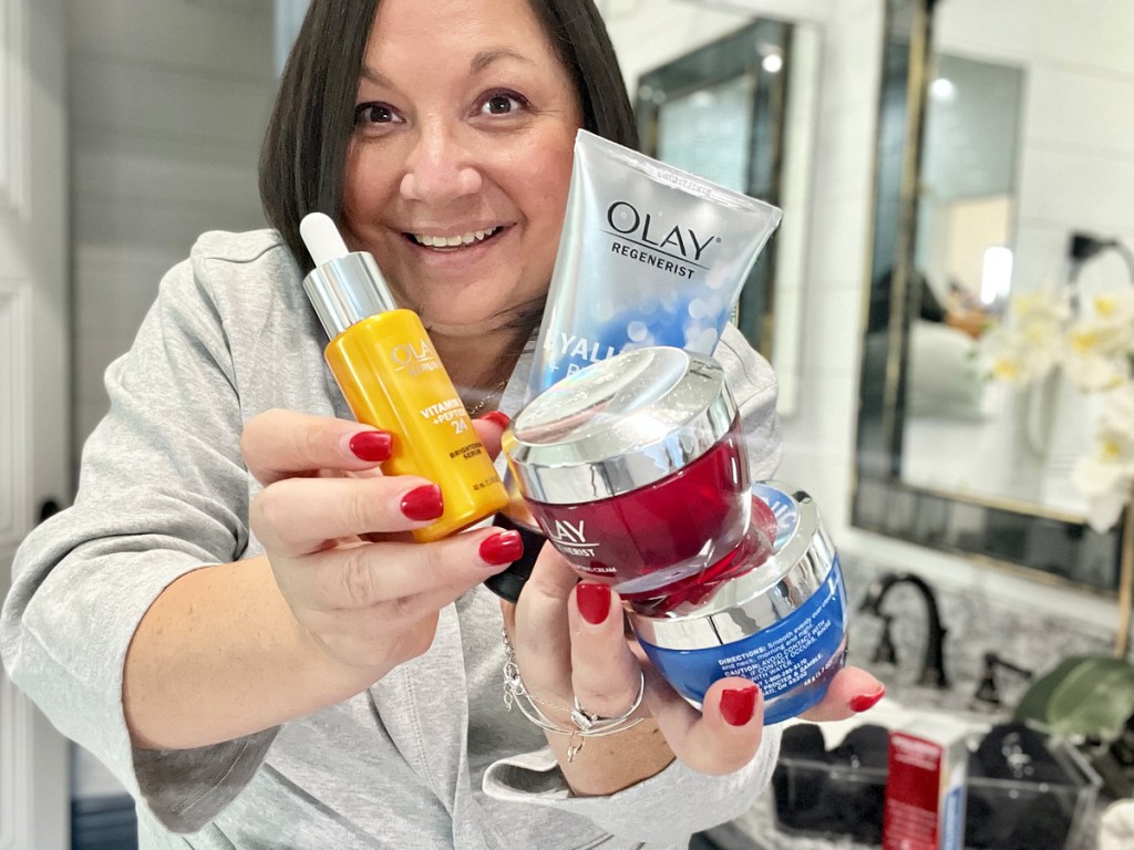 woman holding olay skincare products