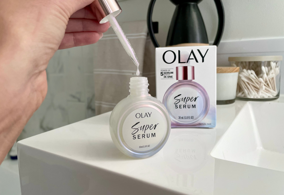 hand holding the dropper of an Olay Super Serum bottle which is one of the best beauty products of 2023