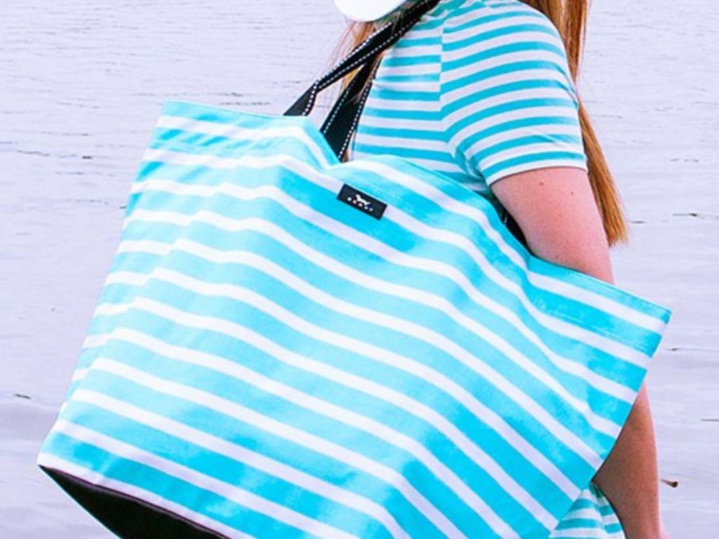 woman carrying Scout by Bungalow blue and white striped tote bag