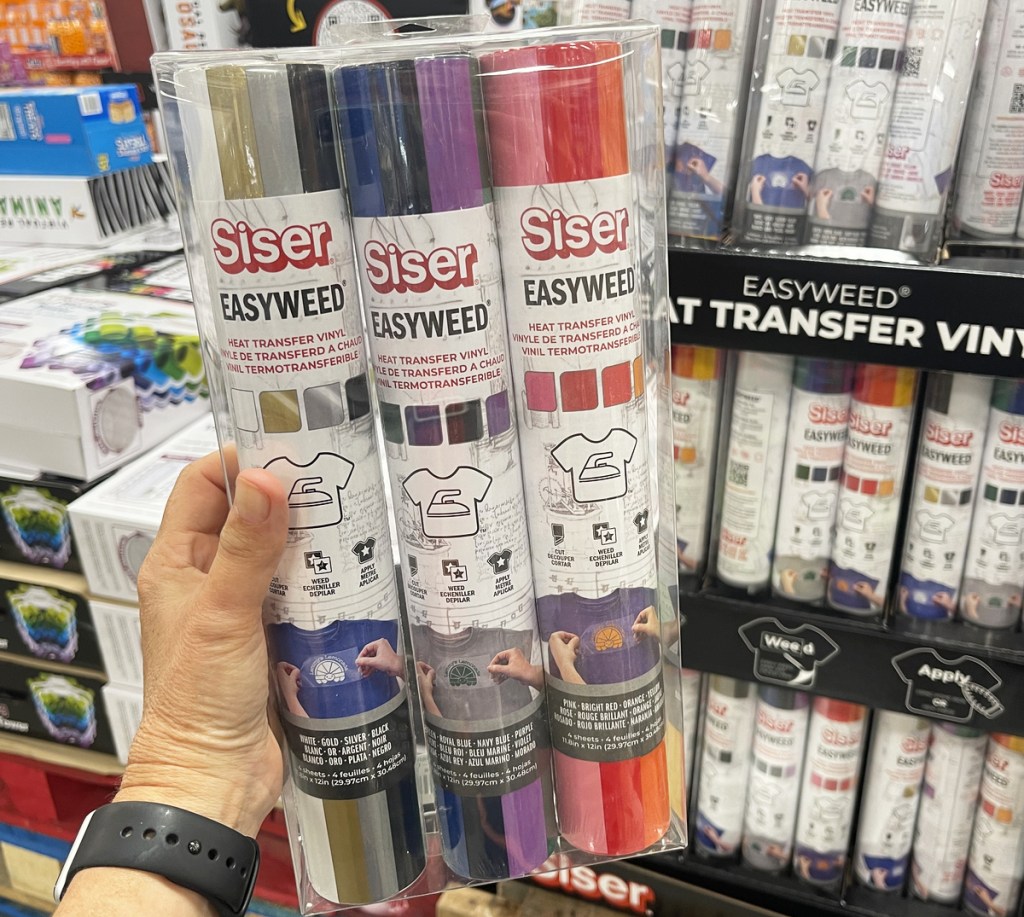 hand holding a set of 3 tubes of crafting vinyl