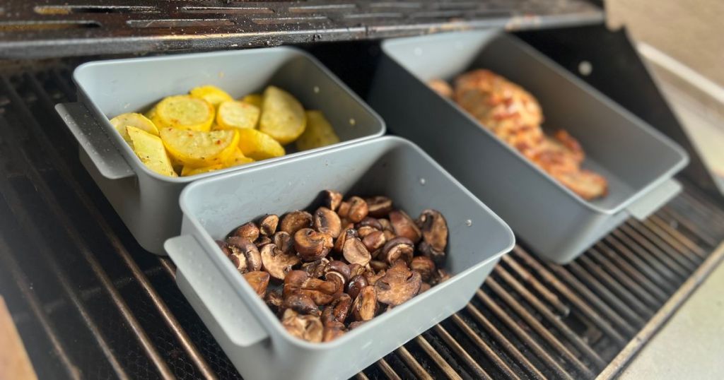 3 containers holding veggies and chicken on grill