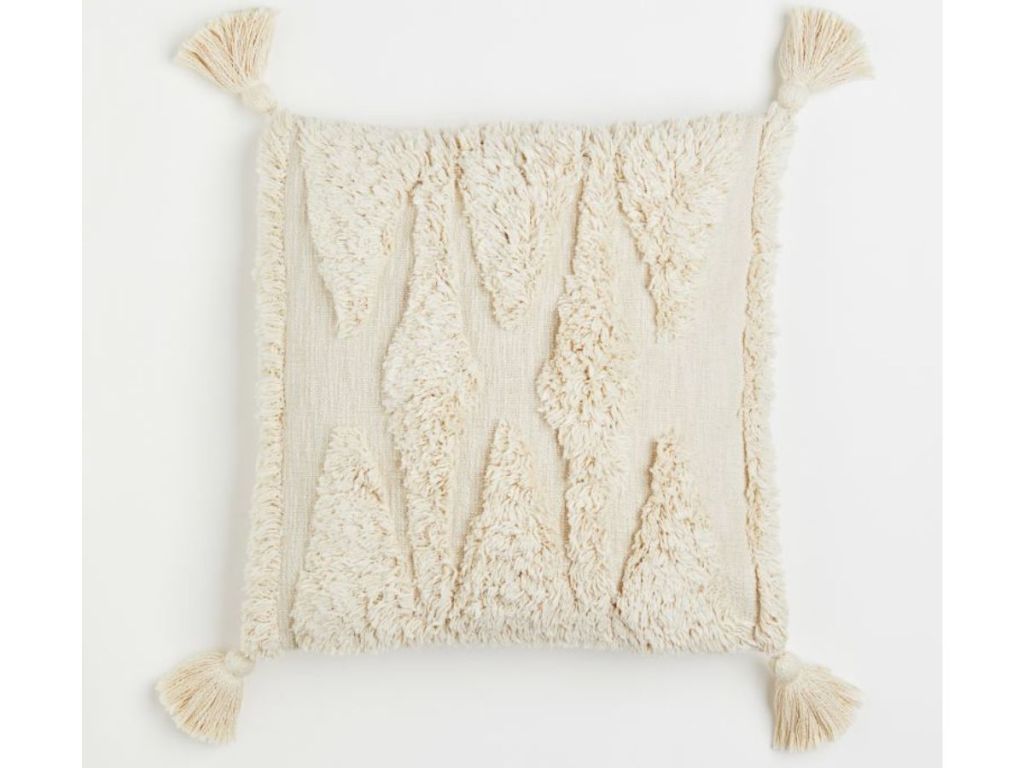 A tufted off-white pillow