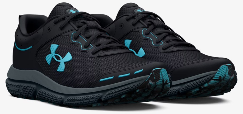 pair of black and blue under armour running shoes