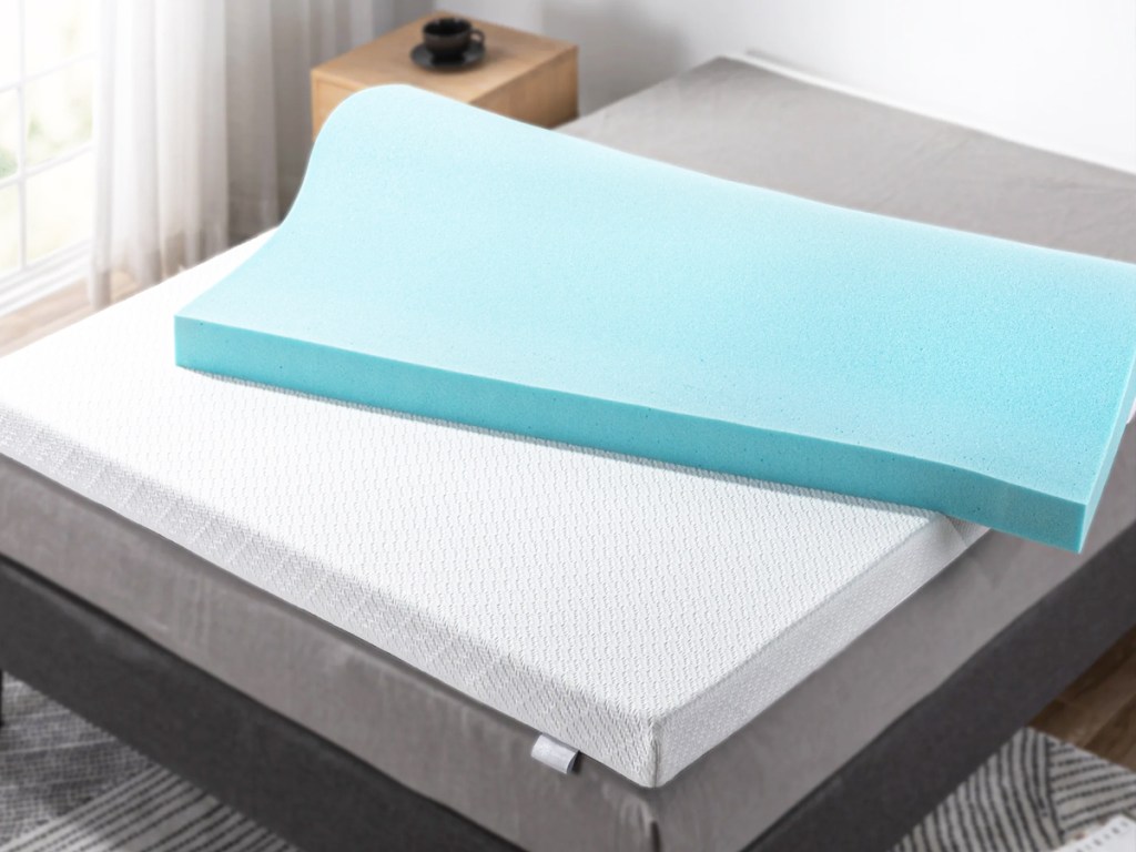 blue and white memory foam mattress topper on bed
