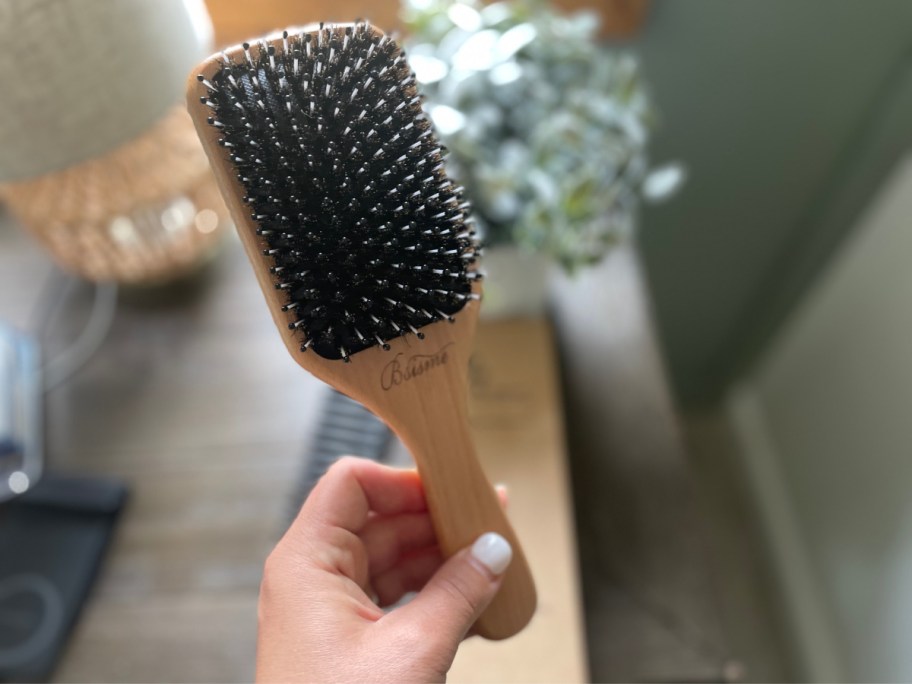 hand holding boar bristle brush