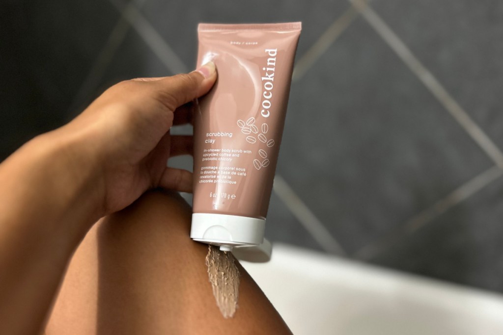 hand squeezing scrub onto leg