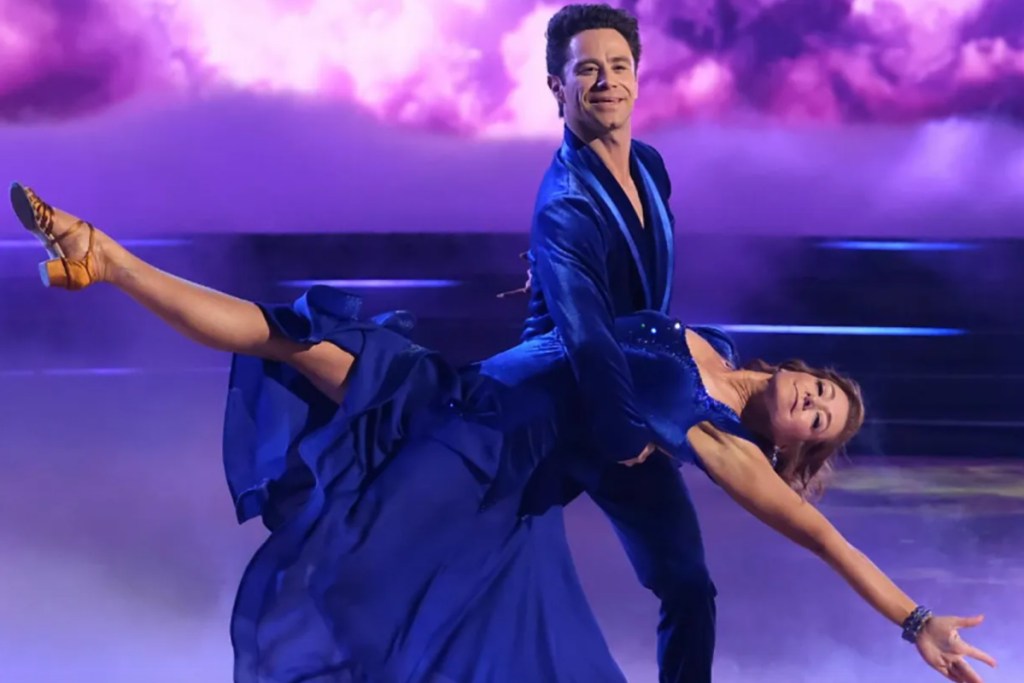 man and woman doing ballroom dancing on stage