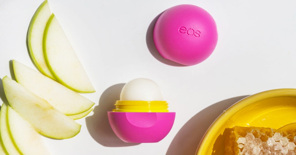 round pink eos lip balm next to apples and honey
