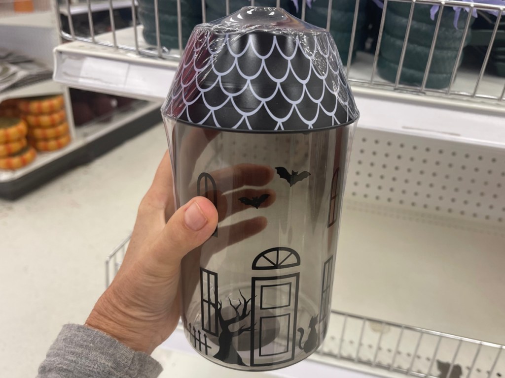 hand holding halloween novelty container at store