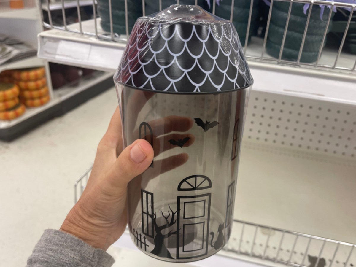 hand holding halloween novelty container at store