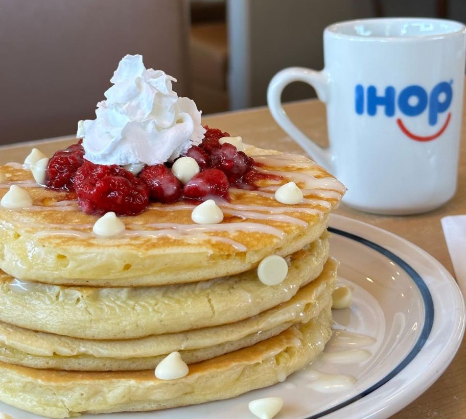a plate of white chcolate raspberry pancakes