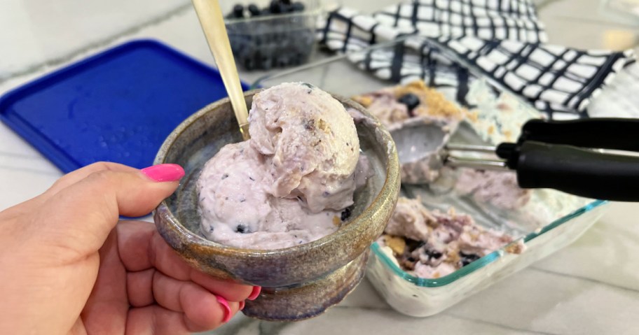 a small bowl of cottage cheese ice cream with blueberry preserves