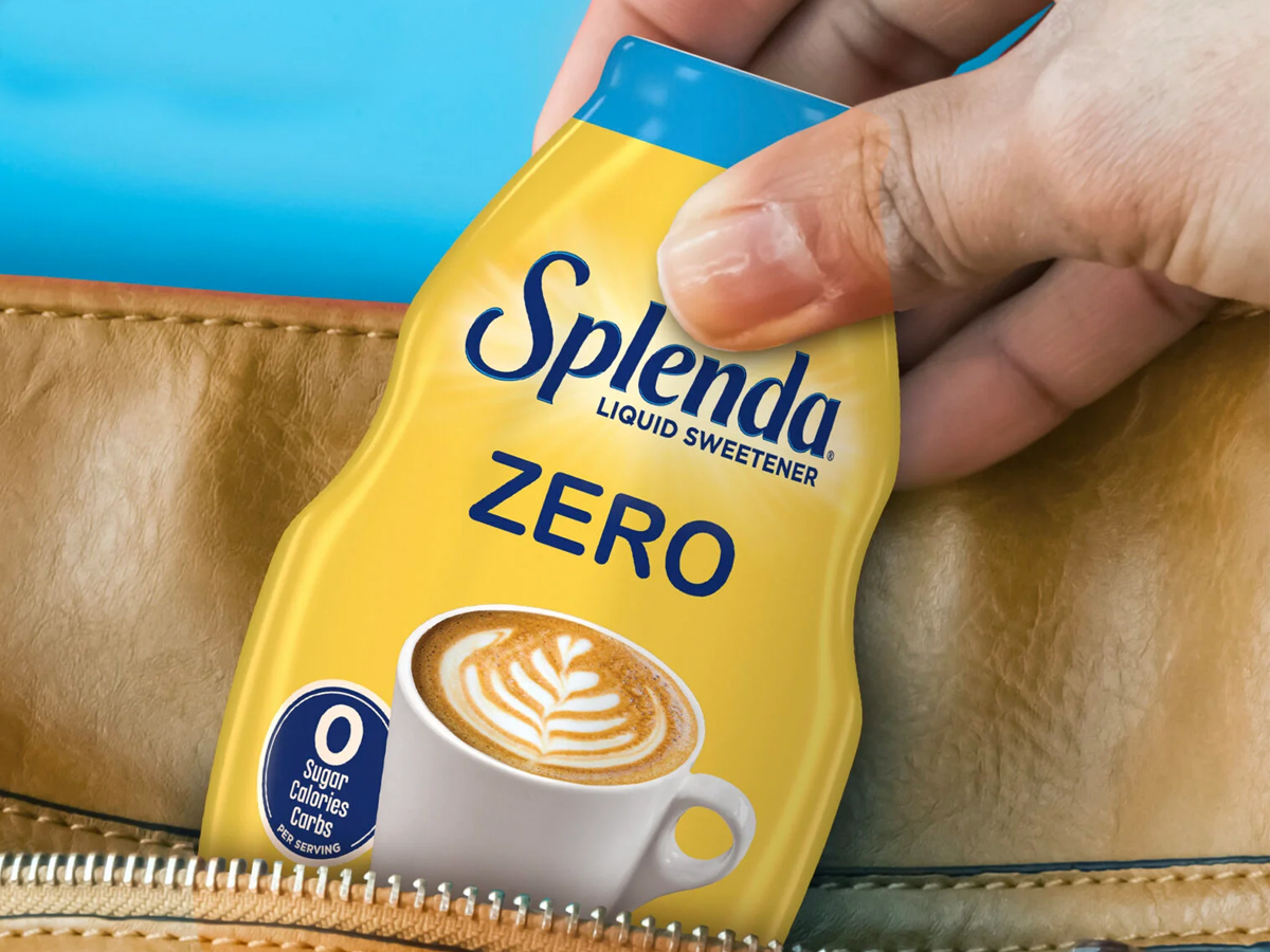 hand putting splenda sweetener in bag