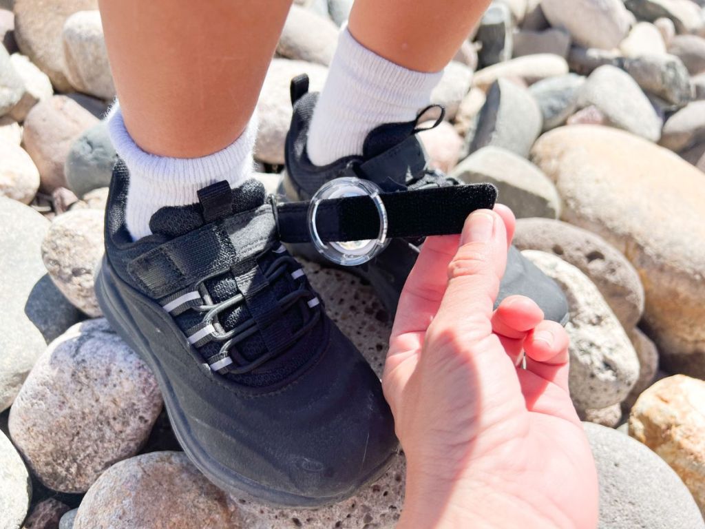 TAGIMALS AirTag Carriers for Kids Shoes shown being put on a shoe