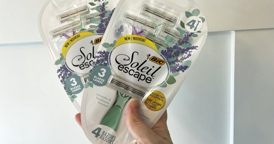 hand holding up two packs of BIC Soleil Escape Women's Disposable Razors
