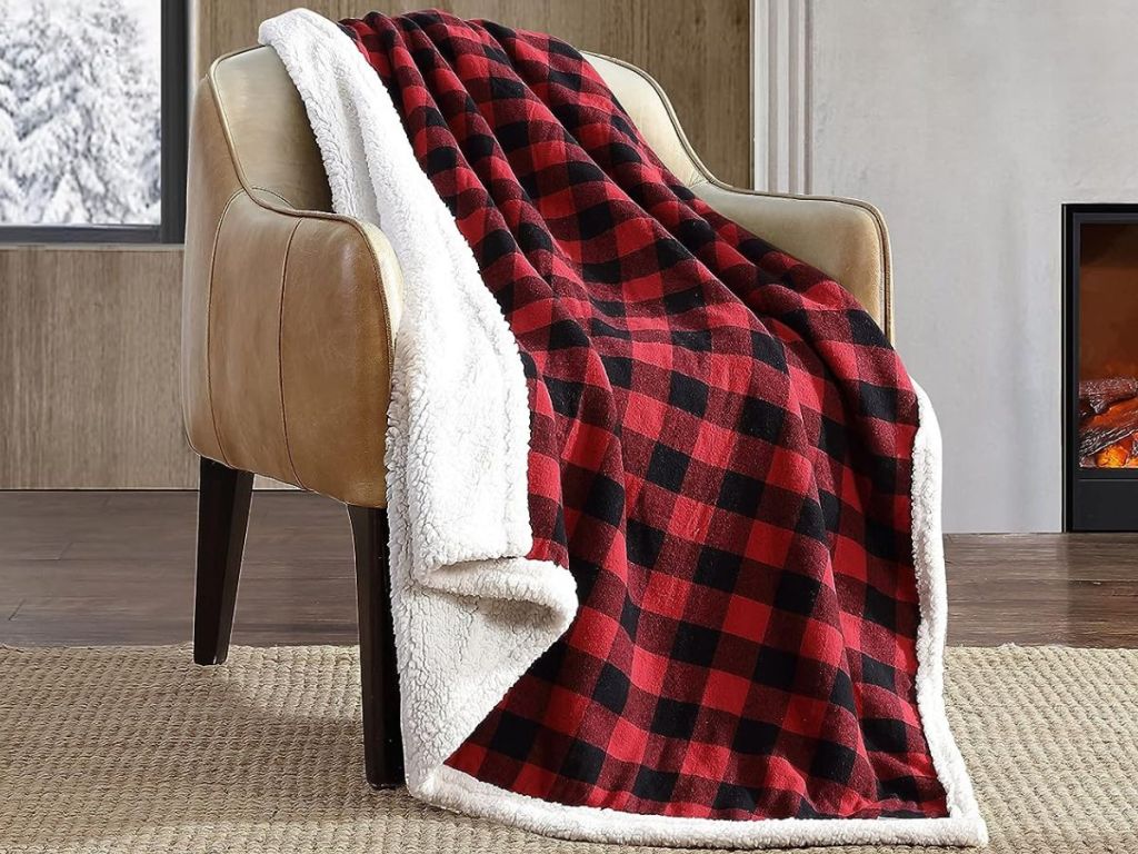 A red buffalo plaid Eddie Bauer throw blanket on a chair