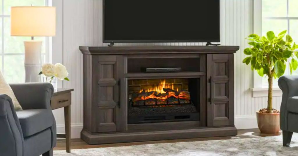 dark brown electric fireplace with TV on top in living room