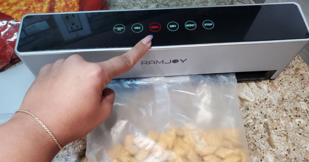 RAMJOY Hands Free Vacuum Food Sealer shown used to seal a bag of crackers