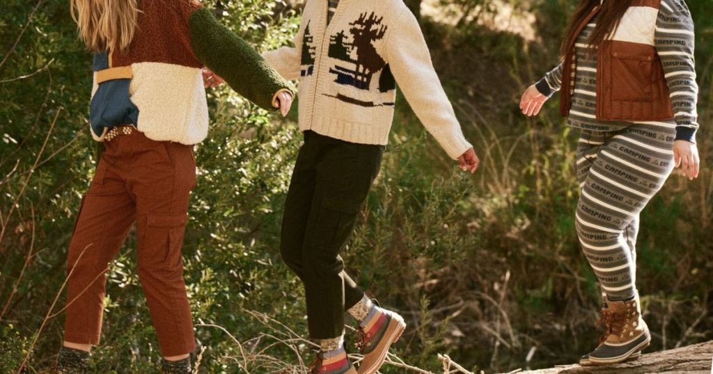 3 women walking in the woods wearing Eddie Bauer Clothing 