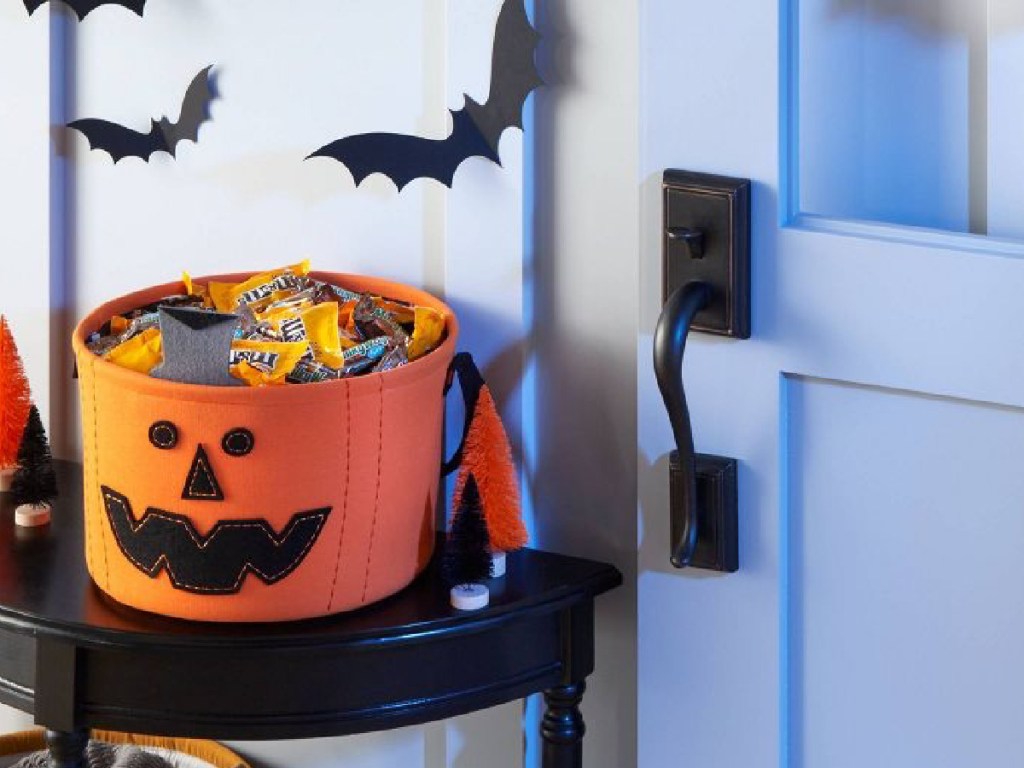 Hyde & EEK! Boutique Fabric Pumpkin Halloween Candy Bowl displayed at the door