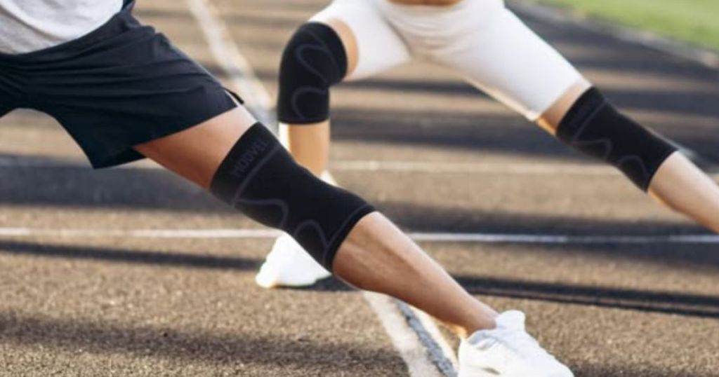 Two people stretching wearing Modvel Knee Brace Compression Sleeves