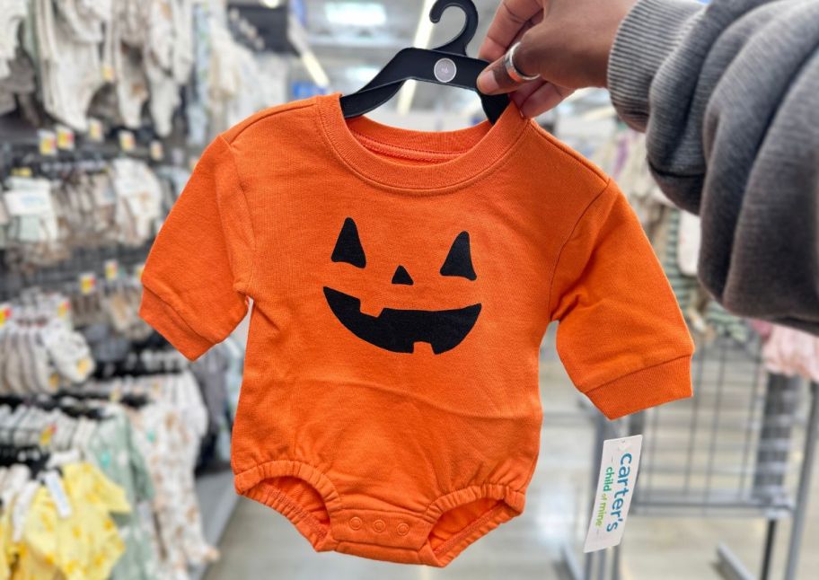 a jack o lantern baby onsie