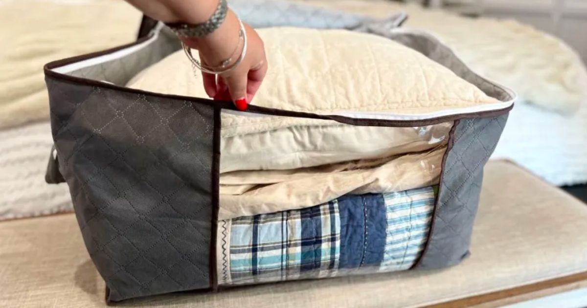  a womans hand opening a foldable storage containers